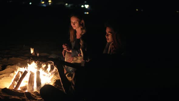 Round Camera Movement Multiracial Group of Young People Sitting By the Bonfire Late at Night and