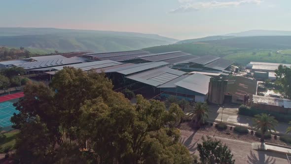 Aerial footage of large dairy farm with solar panels on the roofs