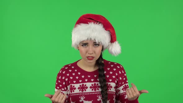 Portrait of Sweety Girl in Santa Claus Hat Is Showing Gesture Come Here. Green Screen