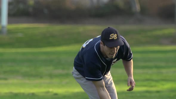 A young man playing catch with a baseball.