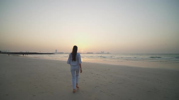 Woman Running on the Beach in Dubai During Sunset