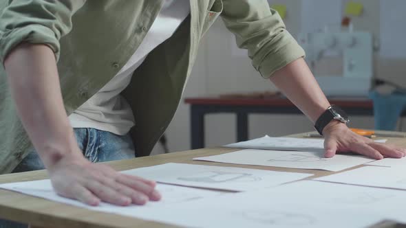 Close Up Of Asian Man Designer Arranging The Bag Sketching Layout Bond At The Office