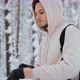 Photographer Puts on Winter Gloves in the Winter Woods - VideoHive Item for Sale