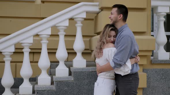 Couple Hugging Near Building