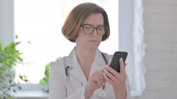 Senior Female Doctor Using Smartphone