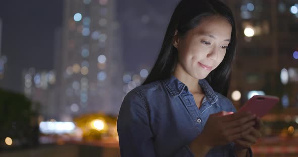 Woman use of smart phone at night