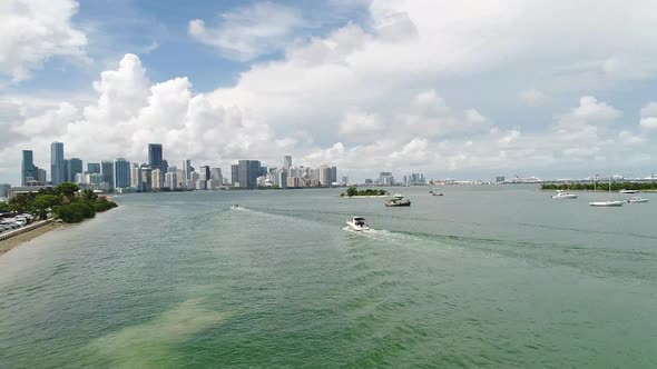 Aerial shot following boat towards the Downtown Miami Skyline