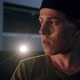 Portrait Shot of Handsome Caucasian Young Man Turning Face to Camera and Looking Shrewd in Dark Hall - VideoHive Item for Sale