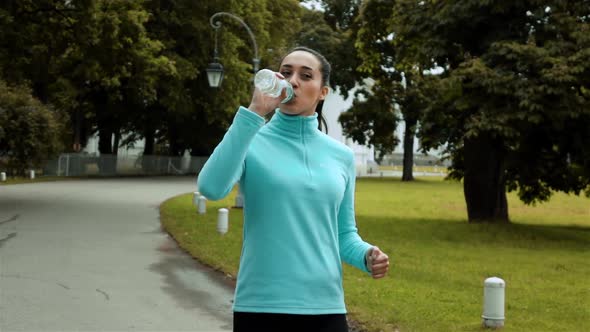 Female Runner Drinking Water Bottle