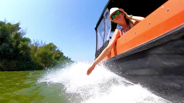 Beautiful Woman Enjoying a boat ride on Danube River, Romania