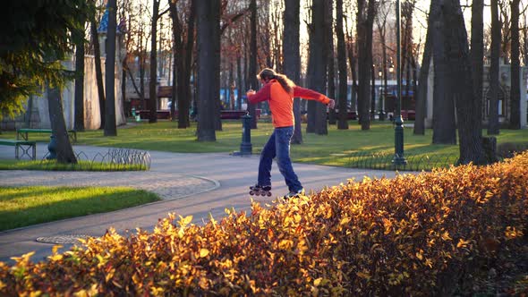 Sporty and Useful Rollerblading. A Man Professionally Trains on Roller Skates, Rides Between