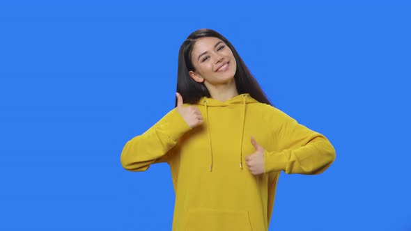 Portrait of Pretty Brunette Showing Thumbs Up Gesture Like