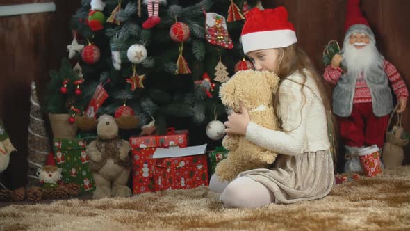 Girl Playing with a Teddy Bear