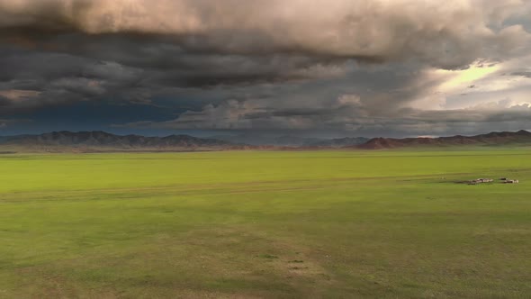 Vast Plain Under Storm Clouds at Magnificent Sunset