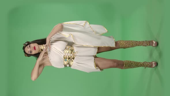 Beautiful Woman in Greek Greece Goddes Dress and Wreath High Fashion. Green Screen. Vertical Video.