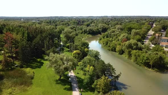 Drone panning across a large park in a city.