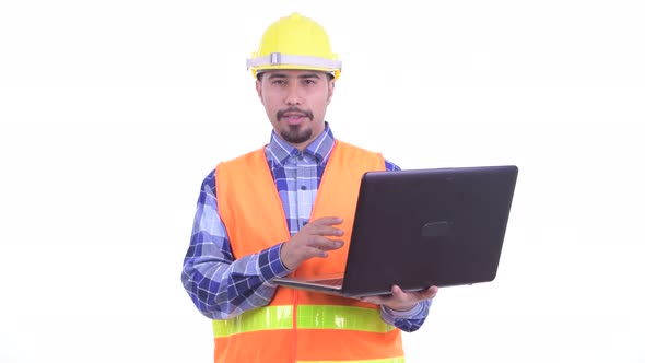 Happy Bearded Persian Man Construction Worker Talking While Using Laptop