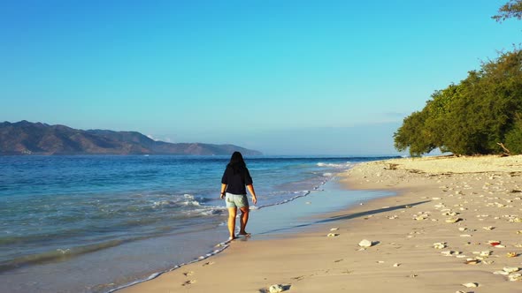 Girl enjoys life on marine island beach journey by blue ocean and white sandy background of the Mald