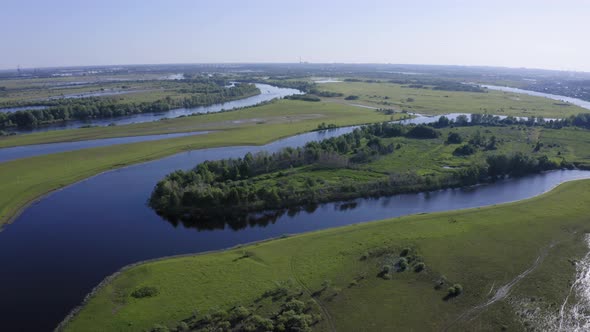 Scenic Aerial View of a River and Green Fields in a Countryside