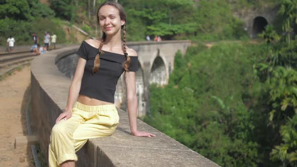 Girl Spends Vacation Sitting on Popular Bridge in Jungle