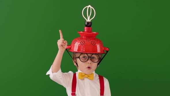 Funny child wearing handmade helmet with lightbulb. Slow motion