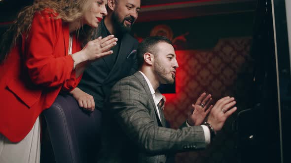 Group of Young People are Rejoice in Victory the Jackpot in a Slot Machine