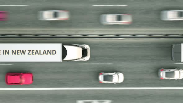 Trucks with MADE IN NEW ZEALAND Text Drive Along the Road