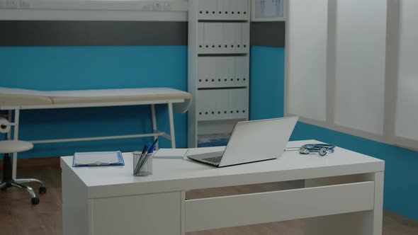 Close Up of White Desk in Empty Doctors Office at Healthcare Clinic