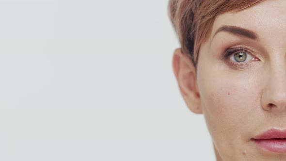 Close-up of middle aged mature woman over white background.