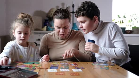 Board educational games with whole family at home in cozy interior.