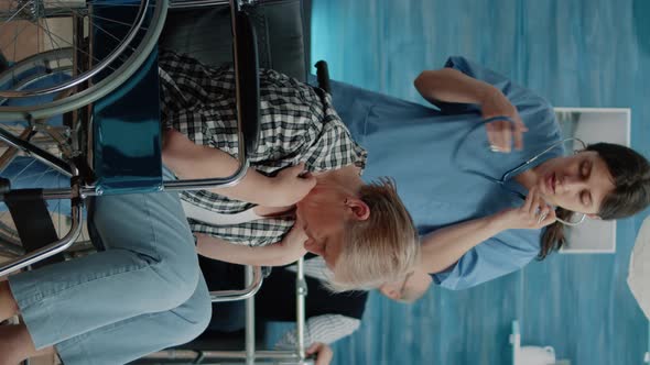 Vertical Video Nurse Using Stethoscope for Heartbeat Checkup on Disabled Woman