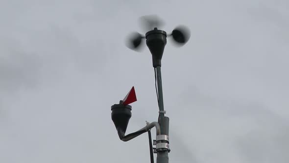 Close-up shot of a weather vane and anemometer.