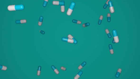 Many pills falling down on blue background.