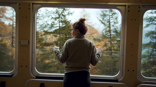 Young Female Traveler on Tourist Train in Mountain