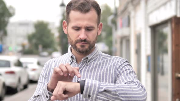 Beard Casual Man Using Smartwatch Outdoor