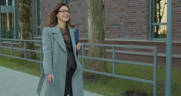 Happy Business Woman with Phone Drinking Coffee to Go Walk Near Office Building