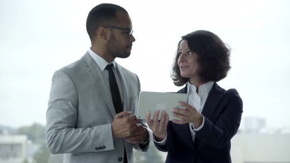 Smiling People Wearing Formal Wear Using Tablet