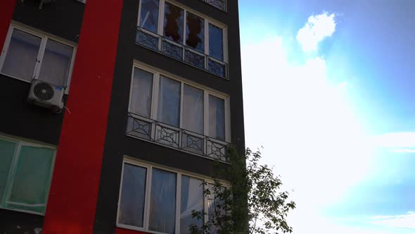 Bombed Modern House on the Left at Background of Summer Sky in Sunbeam