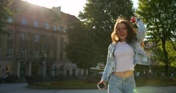 A Cheerful Girl Is Going and Dancing