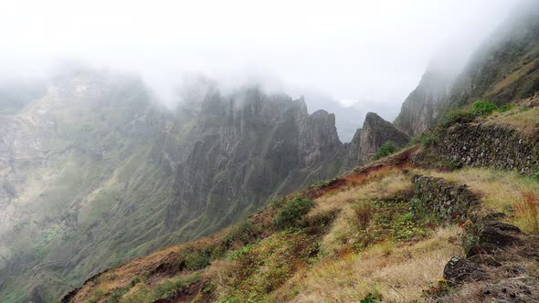 Fog Flowing Over Their Edges of Mountain Peaks. Amazing Mountain Scenery in Xo-Xo Valley. Santo