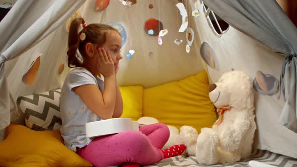 Cheerful Little Girl Plays Small Guitar Sings Songs to a Teddy Bear Tent Home