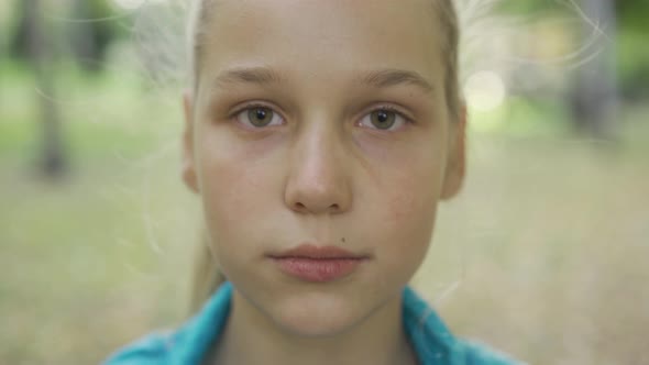 Close up Portrait of a Young Blond Girl Looking at the Camera, Pretty Caucasian Teen Standing
