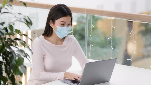 Asian Girl Female Student Elearning with Laptop in Coffee Shop Businesswoman Wearing Medical