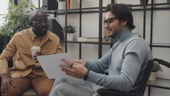 Two Men Talking in Office