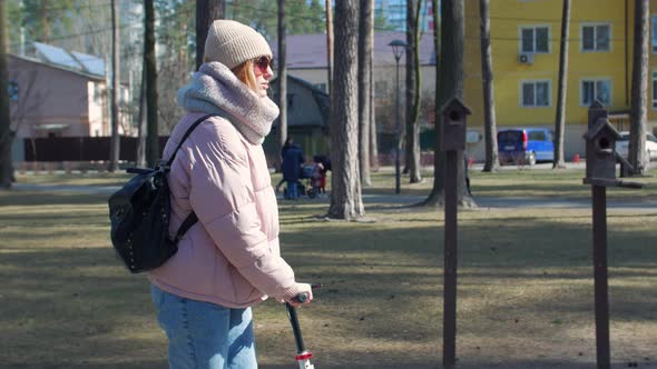 Young Woman Riding Scooter