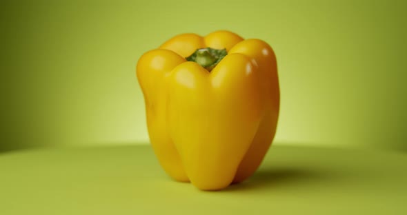 Rotating Fresh Yellow Pepper on Green Background