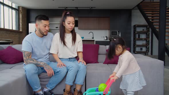 Joyful Asian Family Having Fun Together at Home