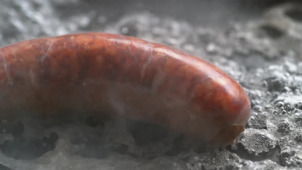 Cooking sausage on non stick fry pan. Slow Motion.