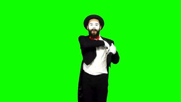 Funny Man Mime Hears the Ring of Telephone and Answers on Green Screen