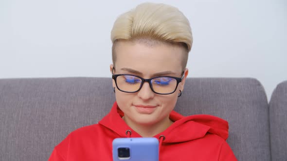 Young female using modern smartphone for entertainment and communication online in 4k video